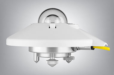 A Kipp & Zonen SMP22 pyranometer instrument showing a white sun shield, a double glass dome, and a yellow cable extending from the side.