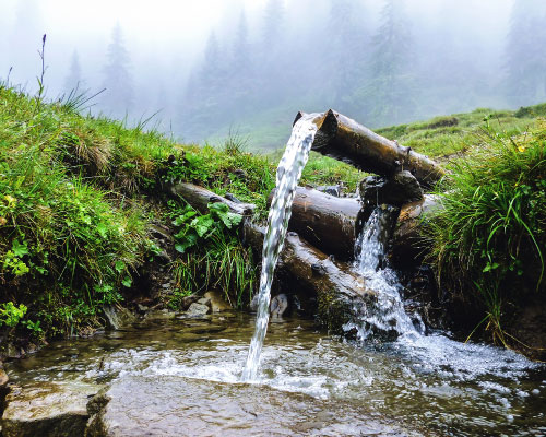 Groundwater well releasing flowing water