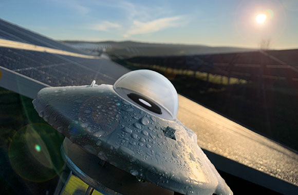 The Kipp & Zonen SMP12 pyranometer instrument mounted in the field, wet with morning dew.